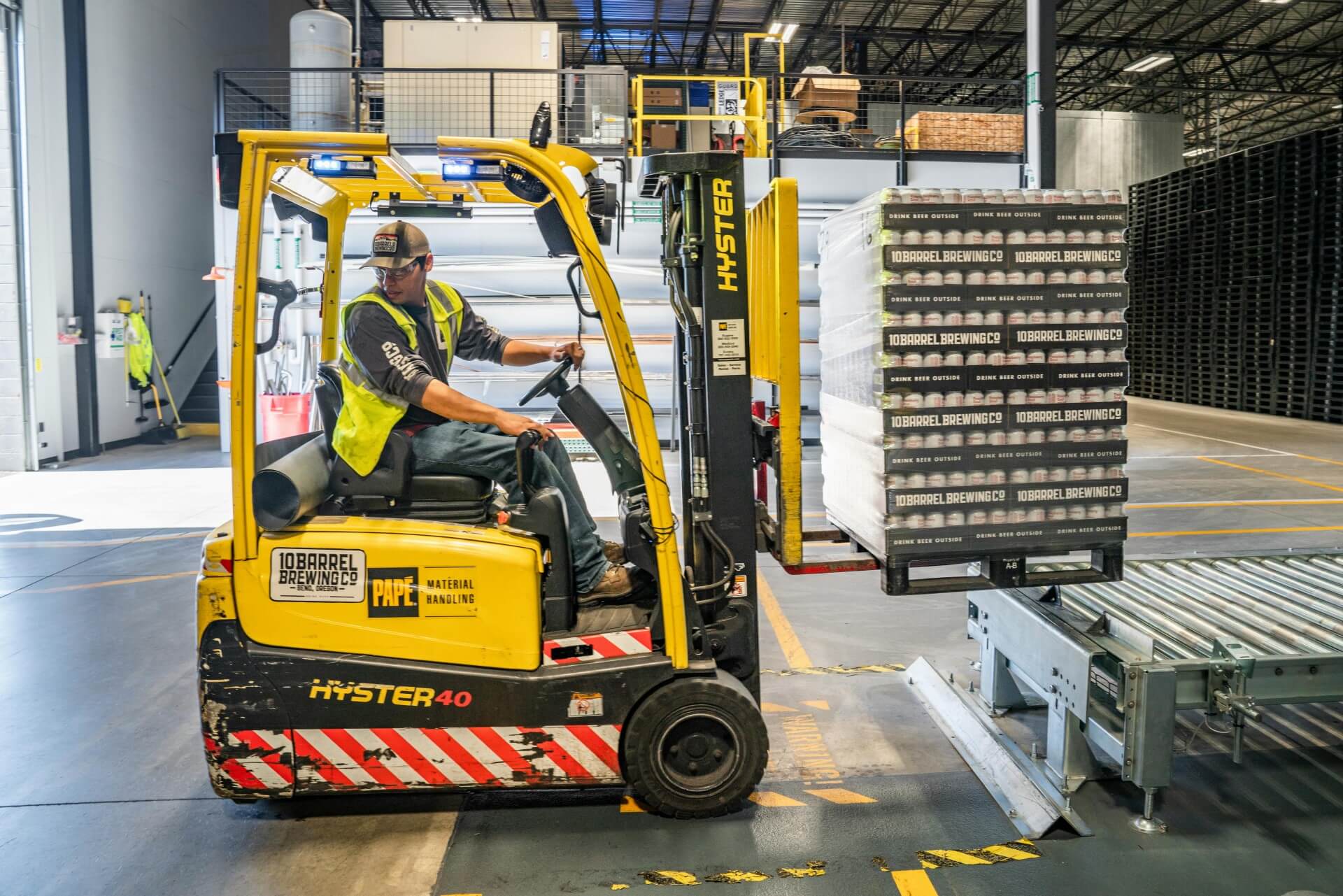 image of a man driving a forklift truck in a warehouse